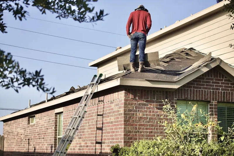 Professional roofer working on a residential roof in Chadwick